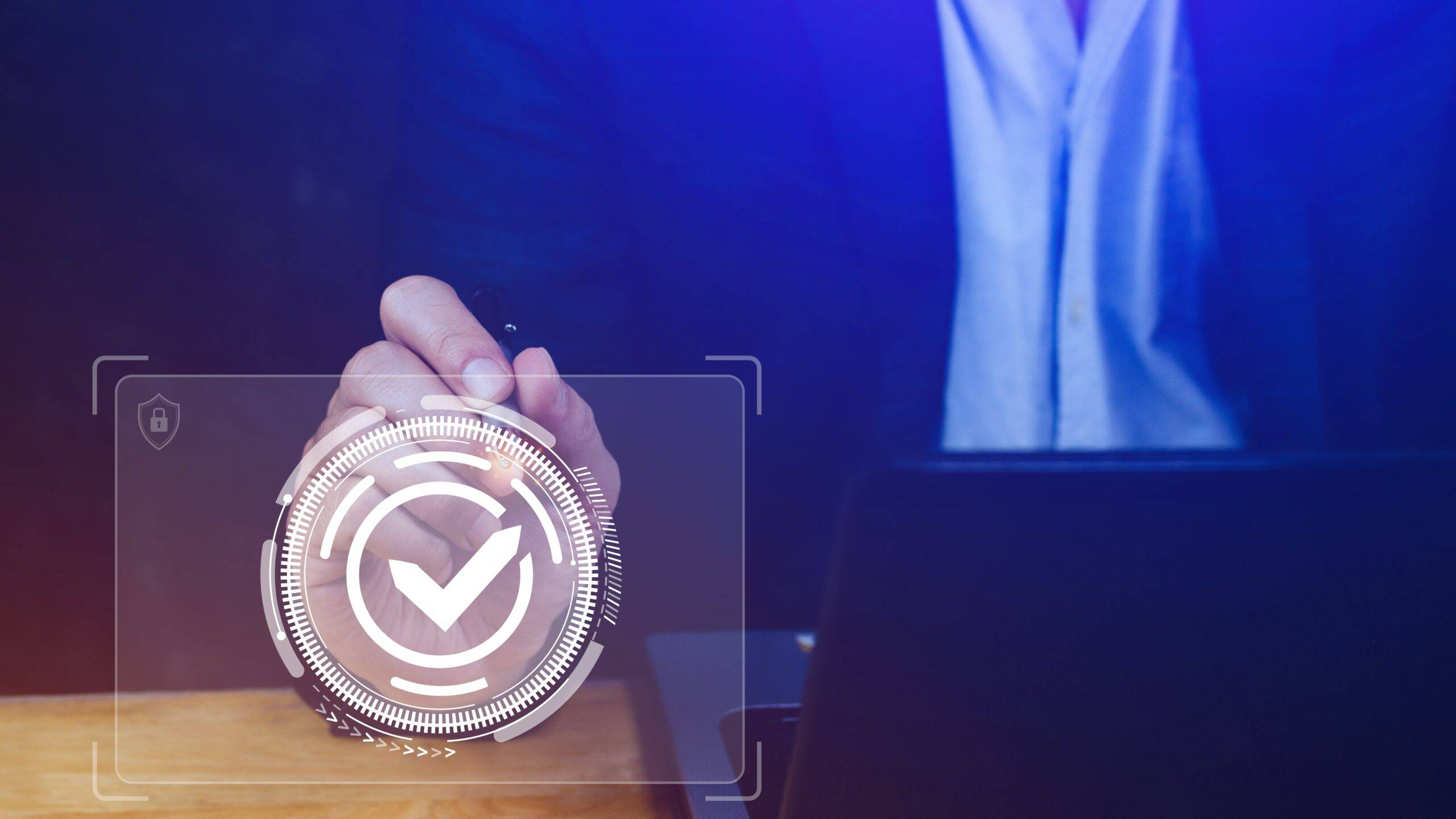 A man in a suit is using a laptop with a check mark on it.